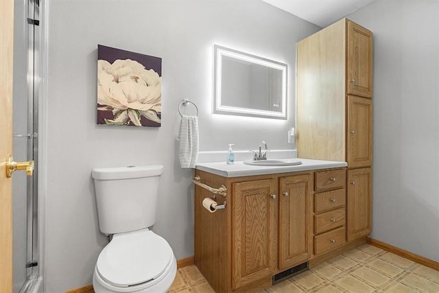 bathroom featuring visible vents, baseboards, toilet, a shower, and vanity