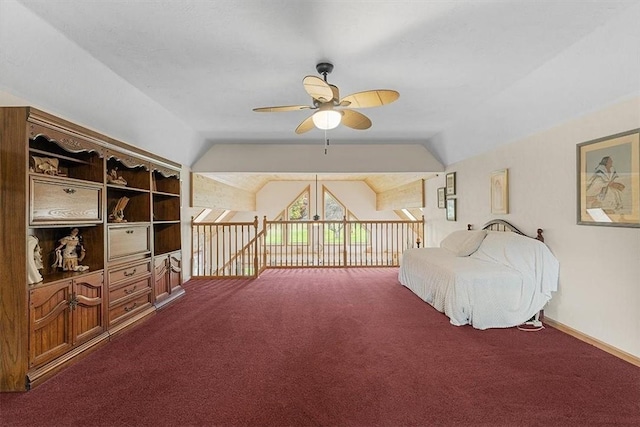bedroom featuring dark carpet, baseboards, and lofted ceiling