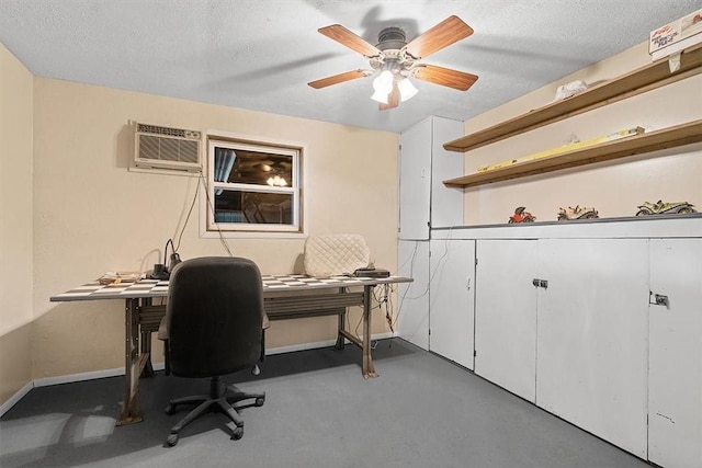office with a wall mounted air conditioner, ceiling fan, baseboards, and a textured ceiling
