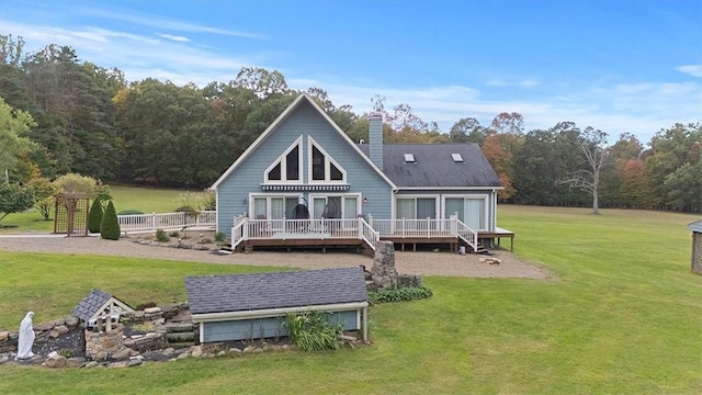 back of house with a yard, a chimney, and a deck