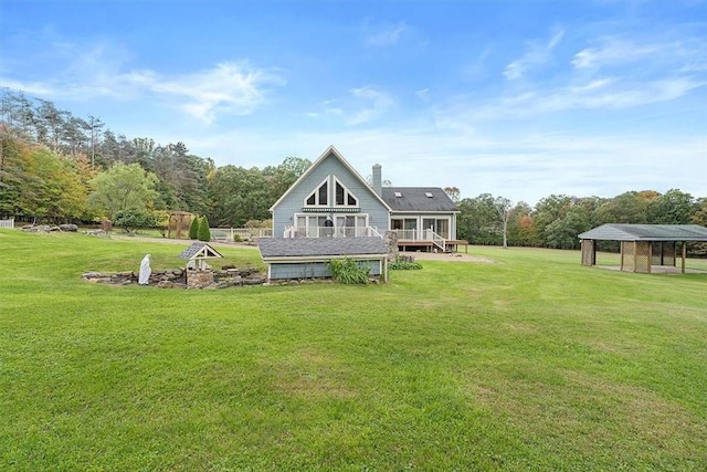back of house with a lawn and a deck