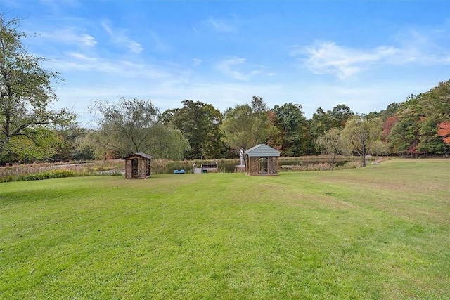 view of yard featuring an outbuilding, a gazebo, and a shed