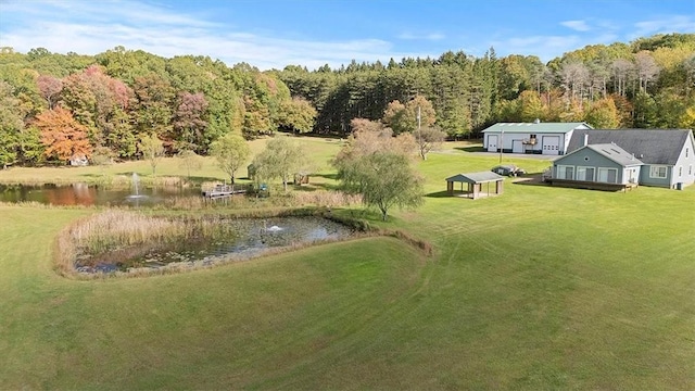 bird's eye view with a water view and a wooded view