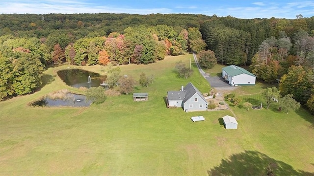 aerial view with a forest view and a water view