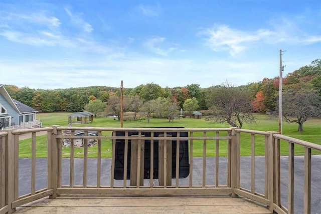 wooden terrace with a yard