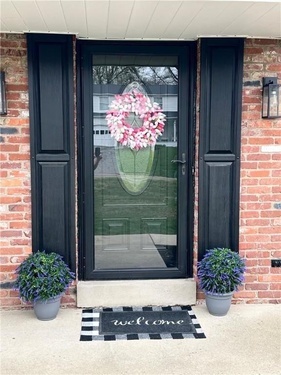 entrance to property with brick siding