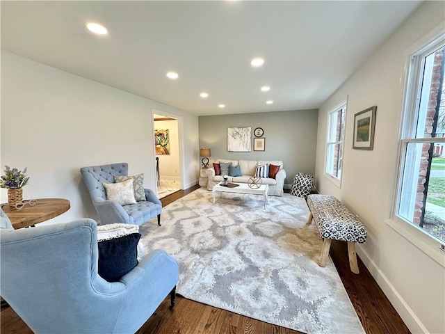 living room with wood finished floors, baseboards, and recessed lighting