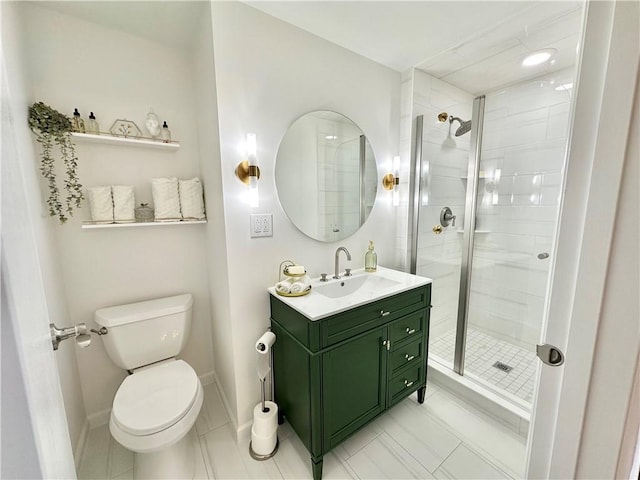 bathroom with toilet, vanity, baseboards, and a stall shower