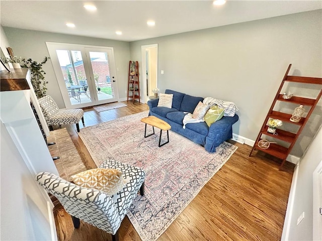 living area with recessed lighting, baseboards, and wood finished floors