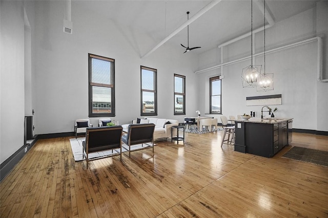 3080 Smallman St, Downtown Pgh, PA 15201 - kitchen with high vaulted ceiling, a sink, wood-type flooring, light countertops, and a chandelier