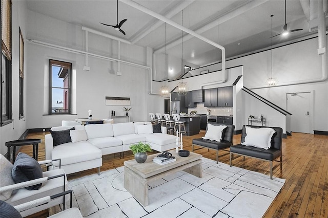 3080 Smallman St, Downtown Pgh, PA 15201 - living area featuring light wood finished floors, a high ceiling, coffered ceiling, and beamed ceiling