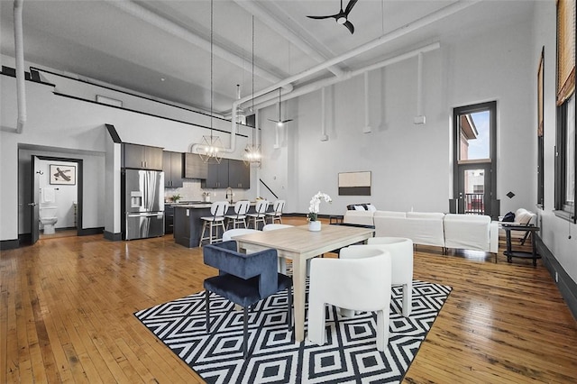 3080 Smallman St, Downtown Pgh, PA 15201 - dining space with a high ceiling, dark wood-type flooring, baseboards, and beam ceiling