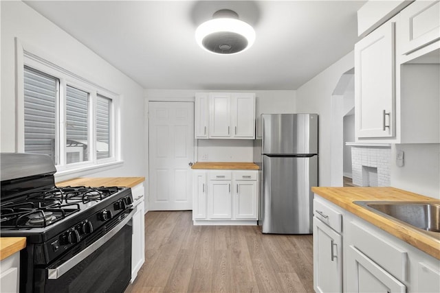 4 Gardner St, Etna, PA 15223 - kitchen featuring light wood-style flooring, wooden counters, freestanding refrigerator, and black gas range oven