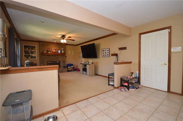 living room featuring baseboards, a ceiling fan, light colored carpet, and a fireplace