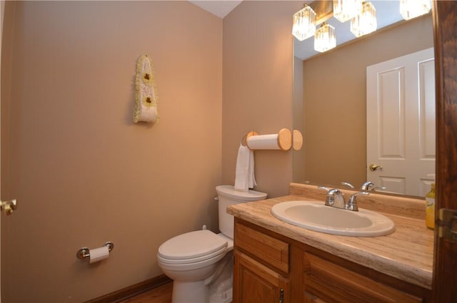 bathroom featuring toilet and vanity