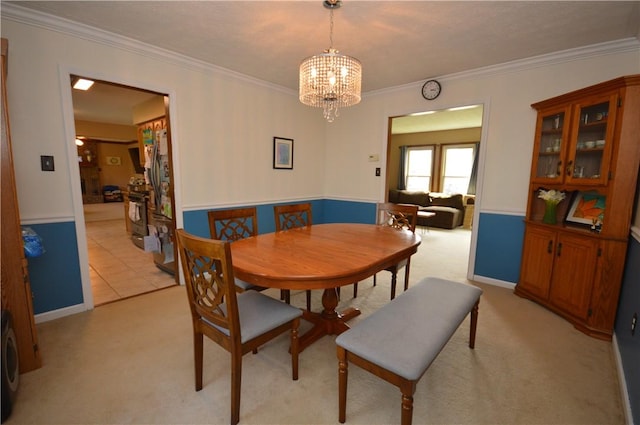 dining space featuring a chandelier, light colored carpet, and crown molding