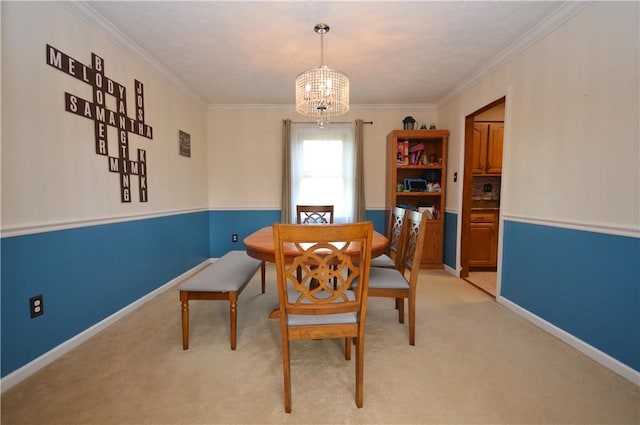dining area with light carpet, an inviting chandelier, baseboards, and ornamental molding