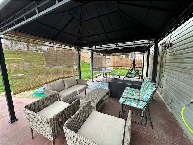 view of patio / terrace with a gazebo, a fenced backyard, and an outdoor hangout area