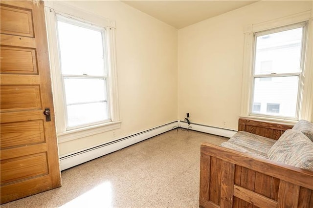 unfurnished room featuring a baseboard heating unit