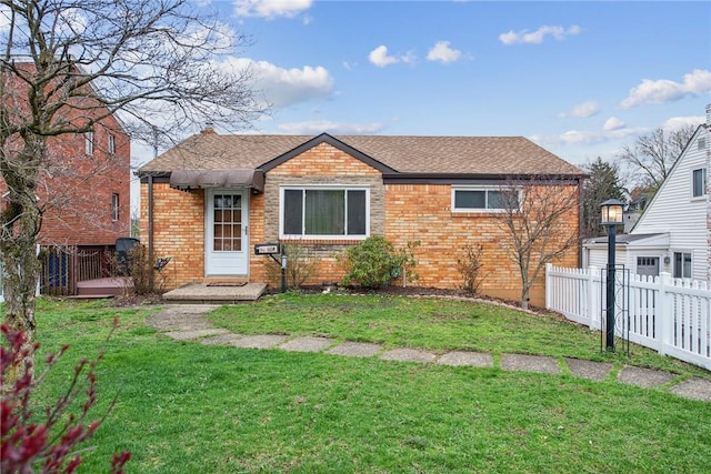 1459 Harris Ave, Banksville/Westwood, PA 15205 - view of front of house featuring roof with shingles, fence, a front lawn, and brick siding