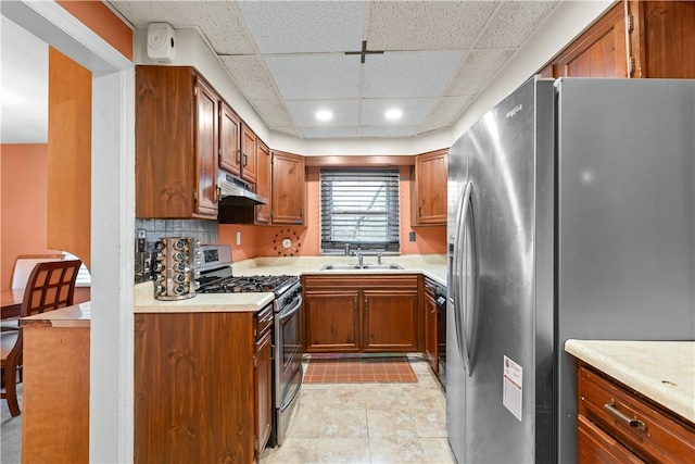 1713 Turner Ave, Wilkinsburg, PA 15221 - kitchen featuring a sink, brown cabinetry, under cabinet range hood, and stainless steel appliances