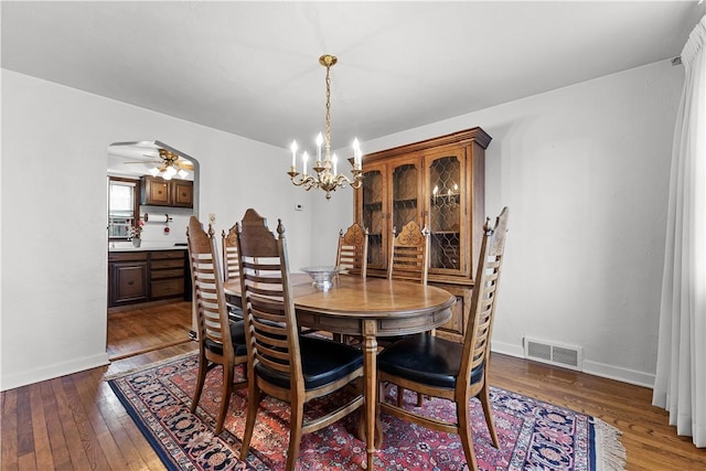 dining room featuring baseboards, wood-type flooring, and visible vents