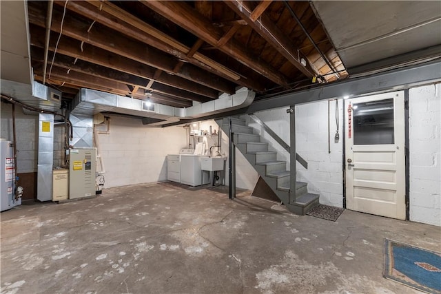unfinished basement with stairway, water heater, washing machine and clothes dryer, concrete block wall, and heating unit