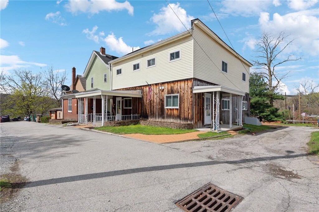 510 Brinton Ave, Pitcairn, PA 15140 - exterior space featuring a porch and a chimney