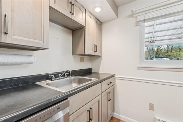 510 Brinton Ave, Pitcairn, PA 15140 - kitchen featuring baseboard heating, dishwasher, a sink, dark countertops, and baseboards