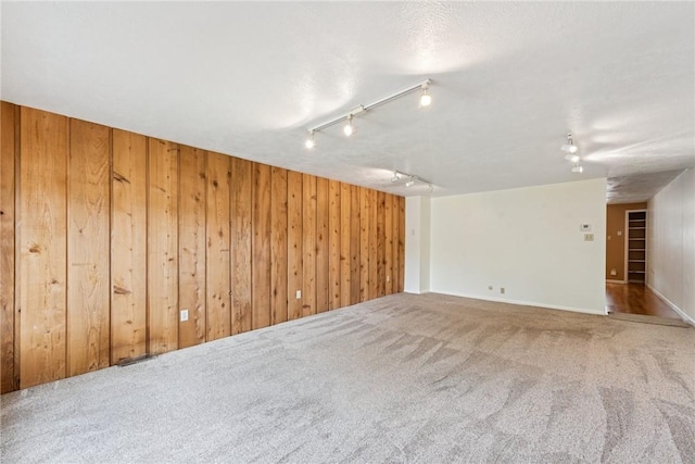510 Brinton Ave, Pitcairn, PA 15140 - carpeted empty room with track lighting and wooden walls