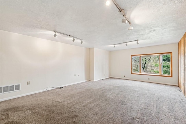 510 Brinton Ave, Pitcairn, PA 15140 - unfurnished room featuring a textured ceiling, carpet flooring, rail lighting, and visible vents