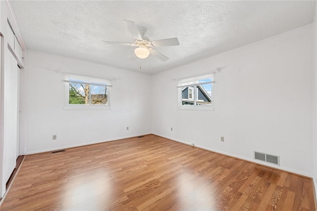 510 Brinton Ave, Pitcairn, PA 15140 - unfurnished room with a textured ceiling, light wood-style floors, visible vents, and a wealth of natural light