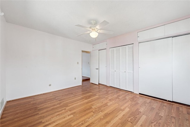510 Brinton Ave, Pitcairn, PA 15140 - unfurnished bedroom with light wood finished floors, two closets, and a ceiling fan