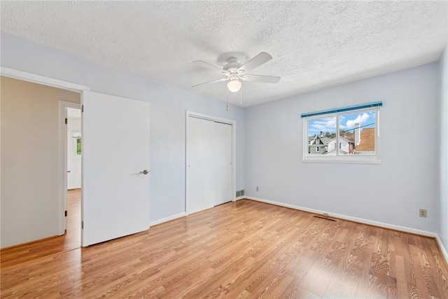510 Brinton Ave, Pitcairn, PA 15140 - unfurnished bedroom with visible vents, a closet, light wood-style floors, and a textured ceiling