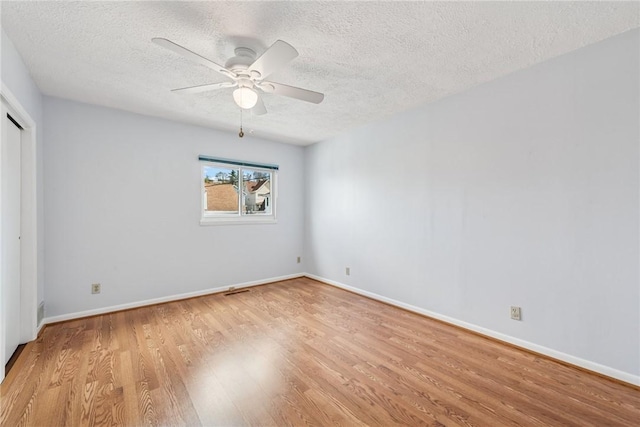 510 Brinton Ave, Pitcairn, PA 15140 - unfurnished bedroom with a closet, baseboards, a textured ceiling, a ceiling fan, and light wood finished floors