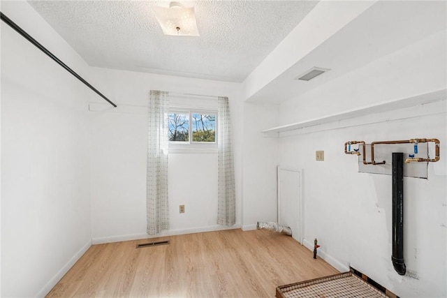 510 Brinton Ave, Pitcairn, PA 15140 - laundry room featuring visible vents, a textured ceiling, baseboards, and wood finished floors