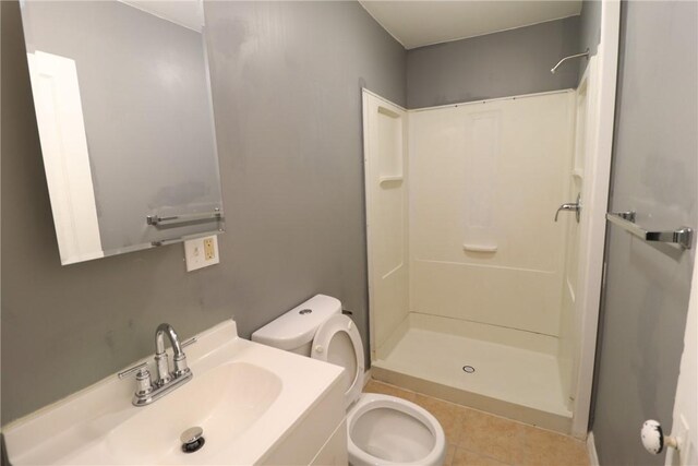 7807 Kelly St, East Hills, PA 15208 - full bath with a shower stall, tile patterned floors, vanity, and toilet