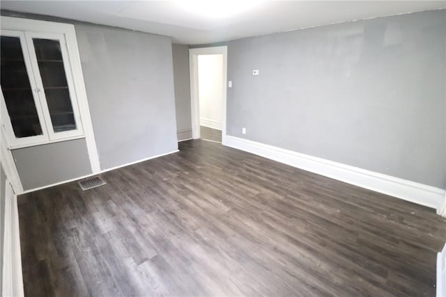 7807 Kelly St, East Hills, PA 15208 - unfurnished room with dark wood-type flooring, visible vents, and baseboards