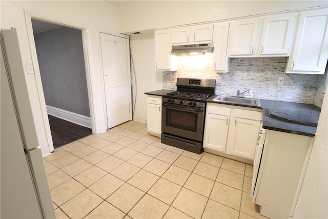 7807 Kelly St, East Hills, PA 15208 - kitchen with light tile patterned floors, white cabinetry, under cabinet range hood, a sink, and range with gas stovetop