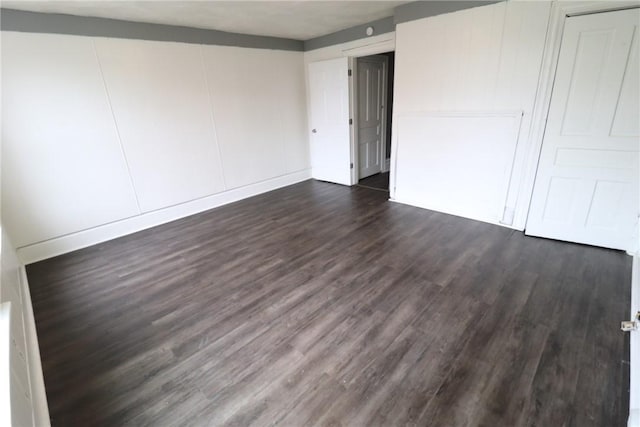 7807 Kelly St, East Hills, PA 15208 - unfurnished bedroom with a closet, dark wood-style flooring, and baseboards