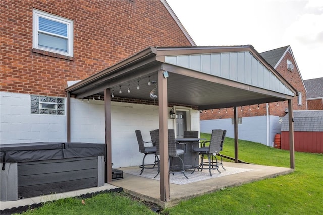view of patio with an outdoor structure and a hot tub