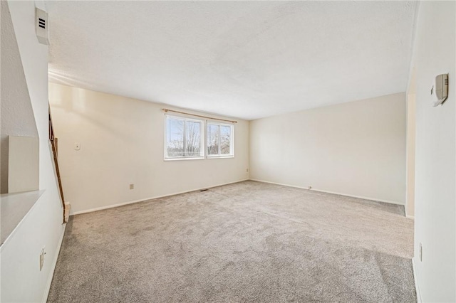 carpeted spare room with baseboards