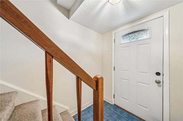 entryway with baseboards and stairs