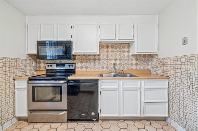 kitchen featuring a sink, light countertops, and black appliances