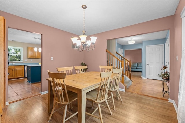 951 Castlegate Cir, Hempfield Twp, PA 15601 - dining space with stairway, a chandelier, and light wood-style floors