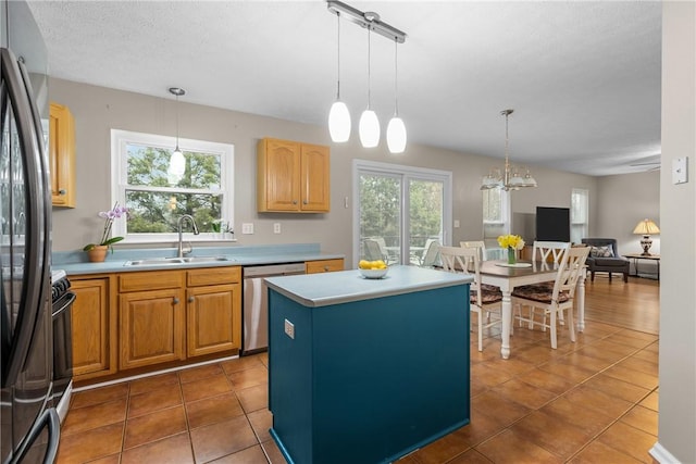 951 Castlegate Cir, Hempfield Twp, PA 15601 - kitchen with stainless steel dishwasher, freestanding refrigerator, plenty of natural light, and tile patterned flooring