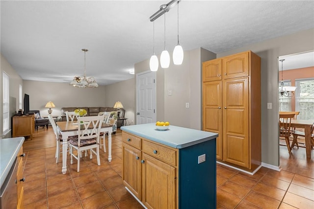 951 Castlegate Cir, Hempfield Twp, PA 15601 - kitchen with a chandelier, tile patterned flooring, open floor plan, a kitchen island, and light countertops