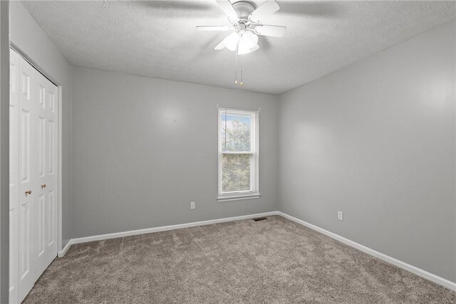 951 Castlegate Cir, Hempfield Twp, PA 15601 - unfurnished bedroom featuring carpet, a closet, a textured ceiling, and ceiling fan