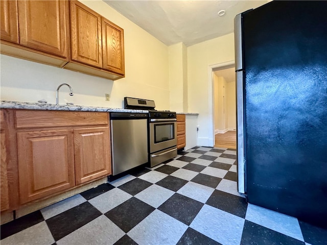 3730 Liberty Ave, Lawrenceville, PA 15201 - kitchen with brown cabinets, appliances with stainless steel finishes, a sink, and dark floors