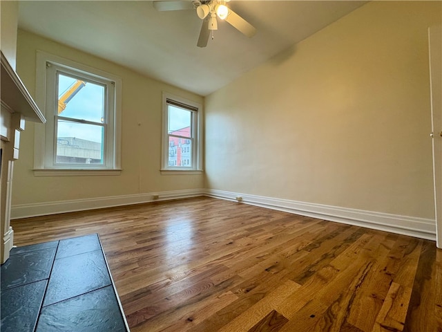 3730 Liberty Ave, Lawrenceville, PA 15201 - spare room with wood finished floors, baseboards, a ceiling fan, and vaulted ceiling